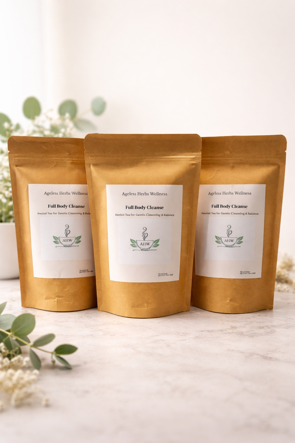 Three gold-colored packages with white labels on a light surface. Full Body Cleanse