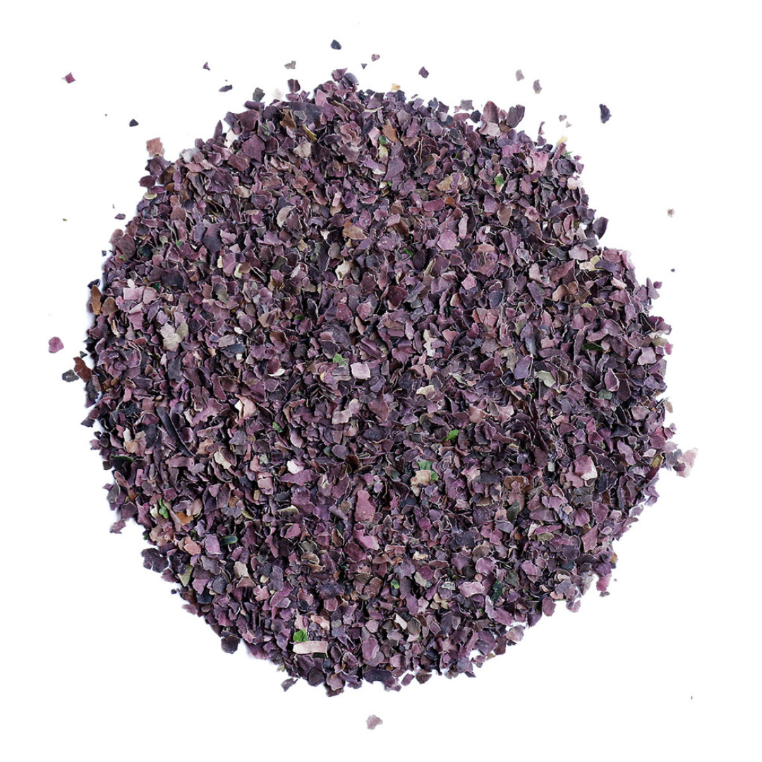 Purple dried herb powder on a white background