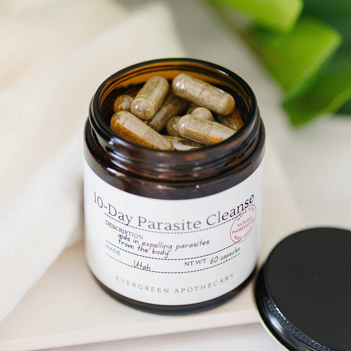 Jar of 10-Day Parasite Cleanse capsules with visible label on a light background