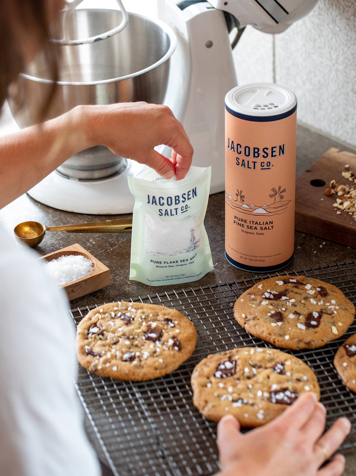 Cookies on a cooling rack with Jacobsen Salt Co. packaging in the background