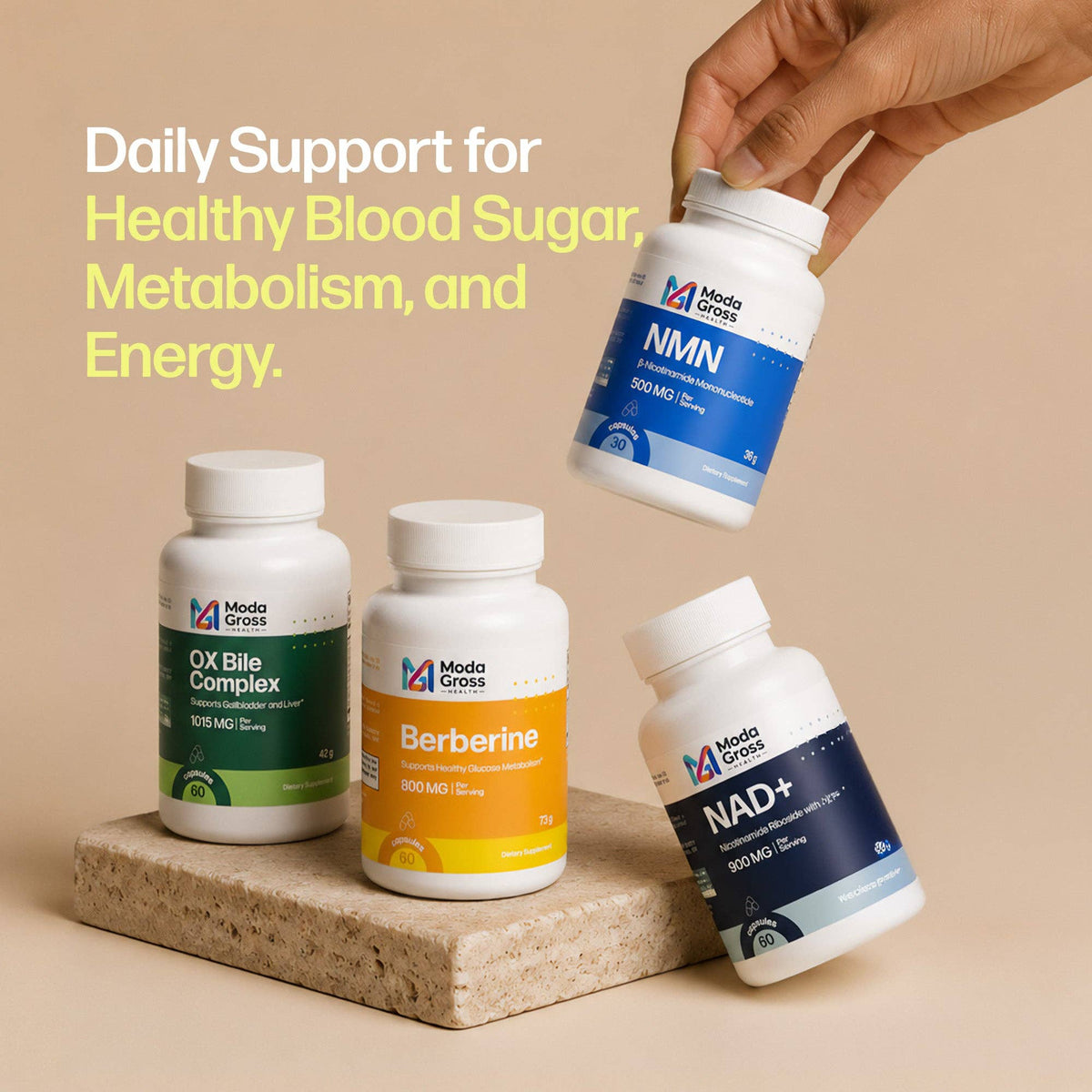 Four Modia Gross supplement bottles arranged on a beige surface with a hand holding one bottle above them. The bottles are white with blue, green, and orange labels, and the text reads 'Daily Support for Healthy Blood Sugar Metabolism, and Energy.