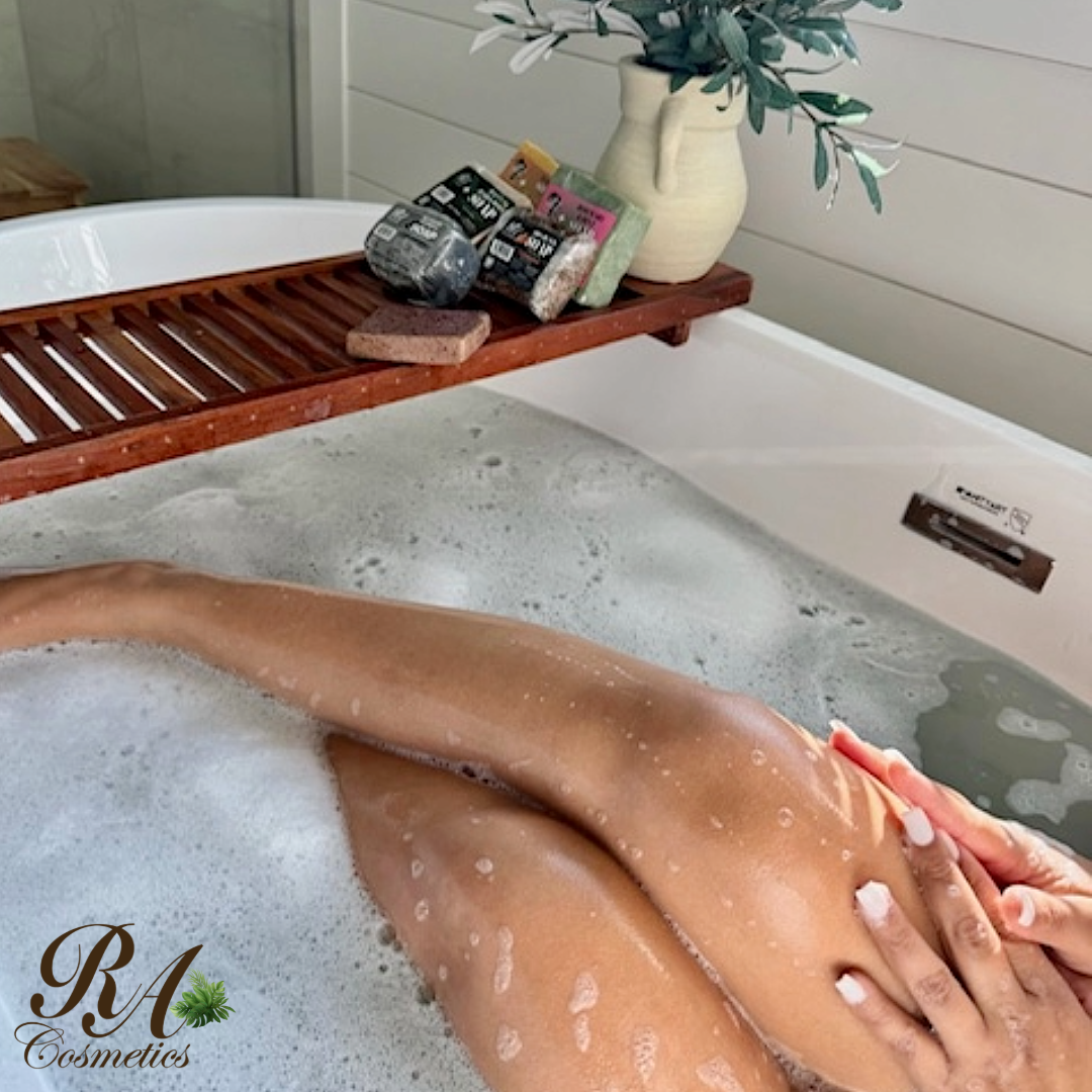 Person relaxing in a bathtub with RA Cosmetics branding.
