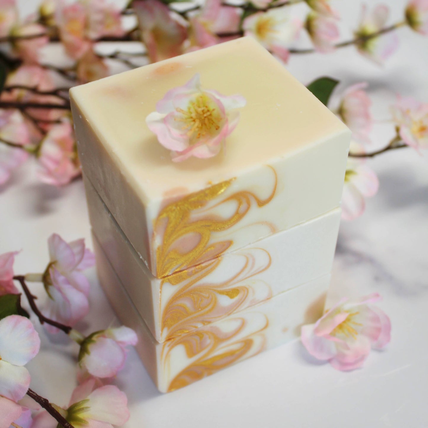 Marbled soap bar with floral design on a white background