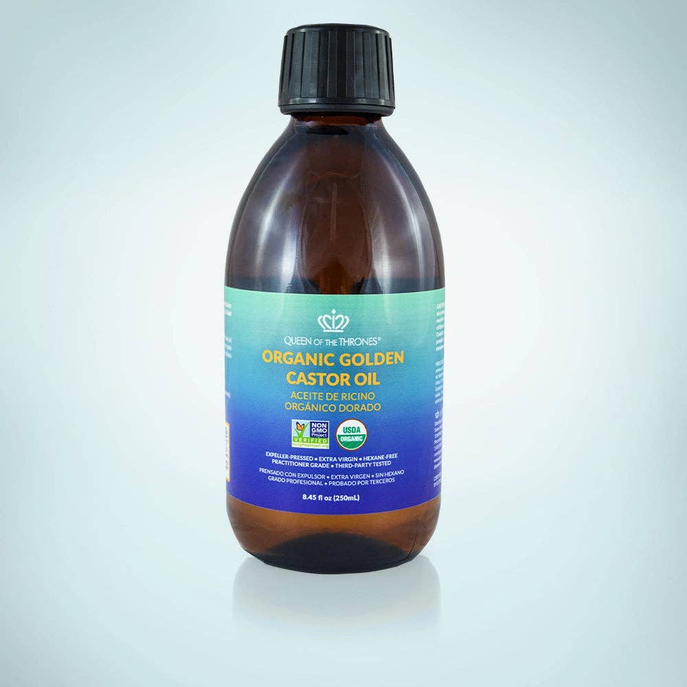 Bottle of Organic Golden Castor Oil with a blue label on a light gray background