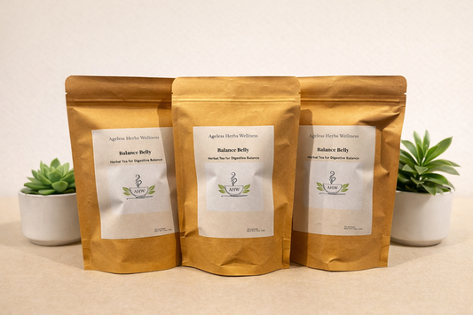 Three packages of Ageless Herbs Wellness Balance Belly Two green plants white background