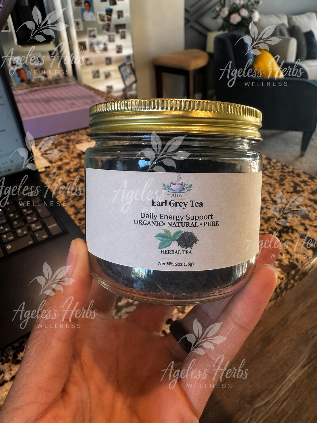 Jar of Earl Grey Tea held in a hand with a blurred indoor background