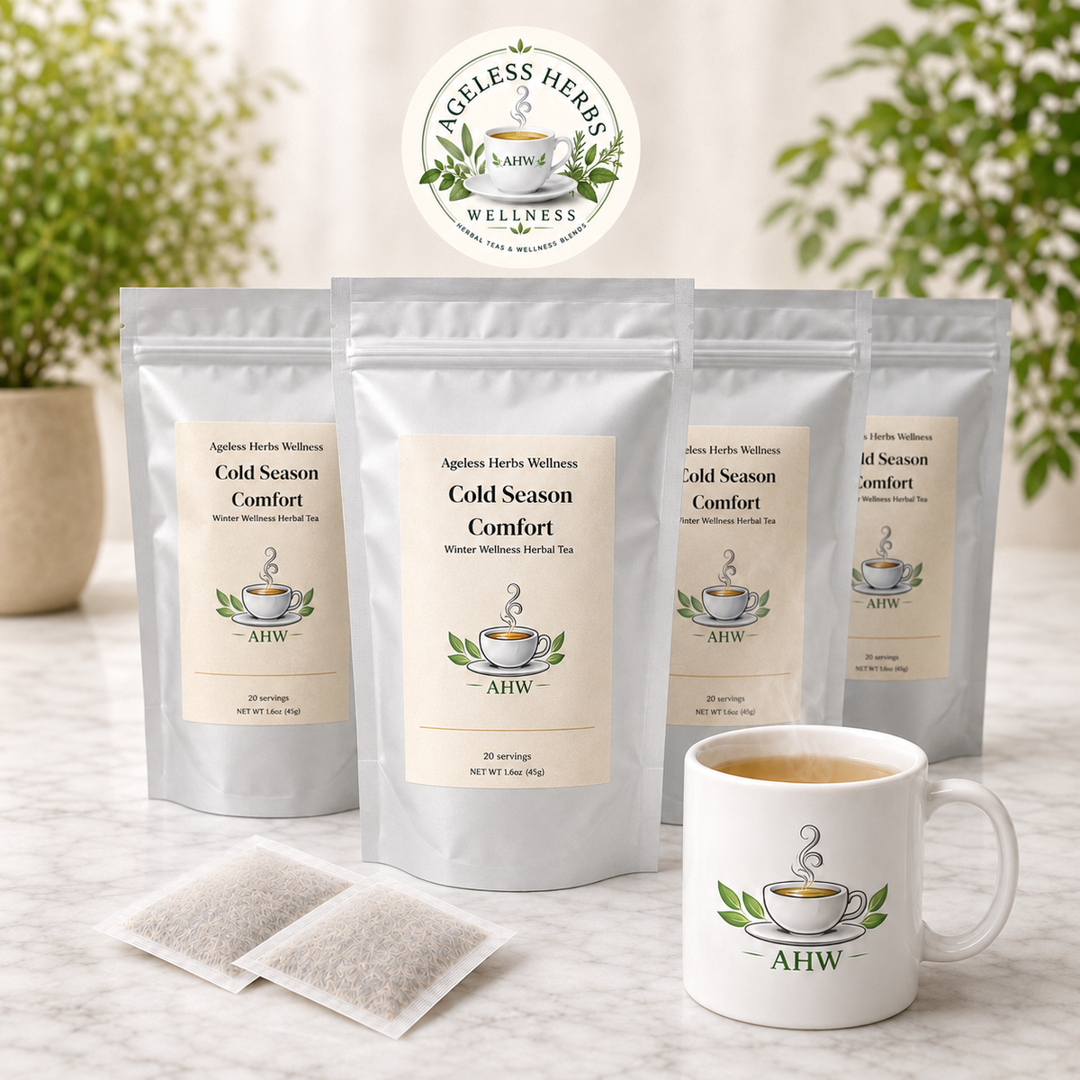 Four stand-up pouches of Ageless Herb Wellness Cold Season Comfort herbal tea are arranged on a marble surface, with two single-serve tea bags in front and a matching white ceramic mug with the AHW logo and tea inside. The background is softly blurred with green foliage and neutral decor.