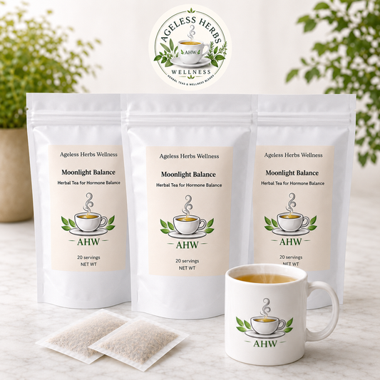 Three stand-up pouches of Ageless Herbs Wellness Moonlight Balance herbal tea are displayed on a light marble surface, with two tea bags and a matching white ceramic mug in front. The background features a soft-focus green garden setting.