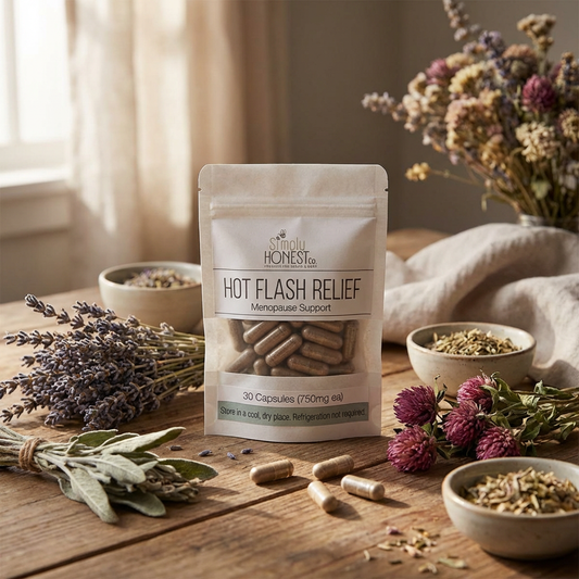 Hot Flash Relief menopause support capsules displayed with lavender, sage, red clover, and dried herbs on a wooden table.