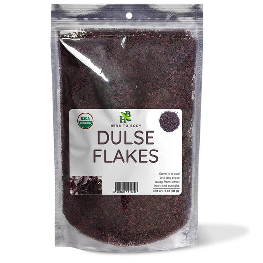 A clear stand-up pouch of herbs to body Dulse Flakes, showing the dark brown dried flakes inside, with a white label on the front.